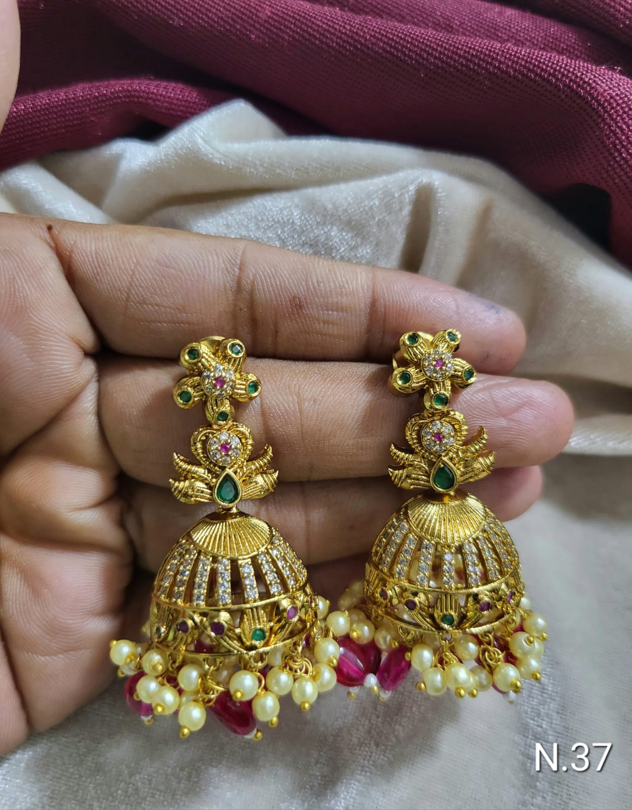 Premium Matte Gold Jhumkas featuring Ruby-Pink Accents and Cluster Pearl Fringes