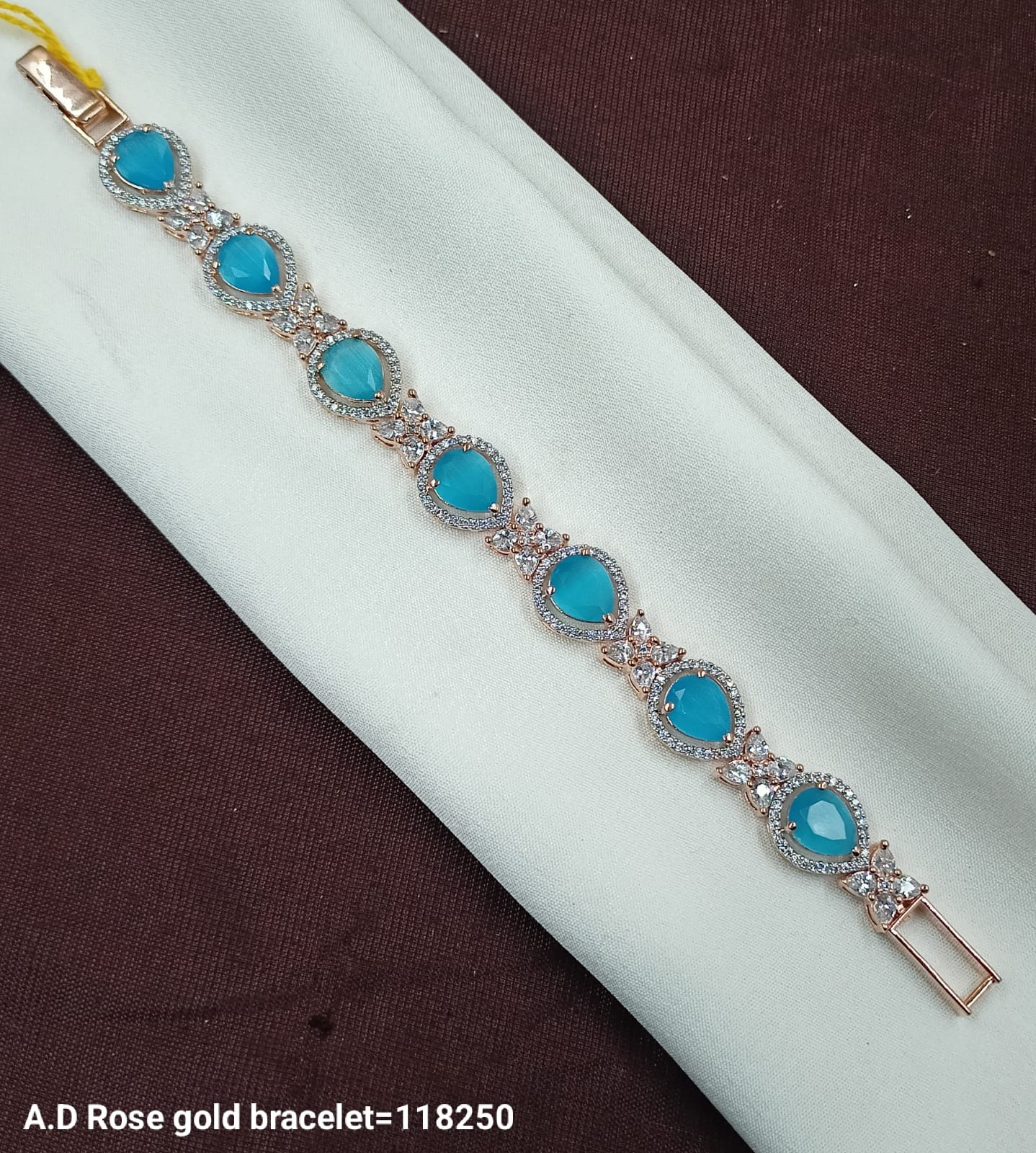 Elegant A.D Rose Gold Bracelet with Pear-Cut Blue Stones & Crystal Accents
