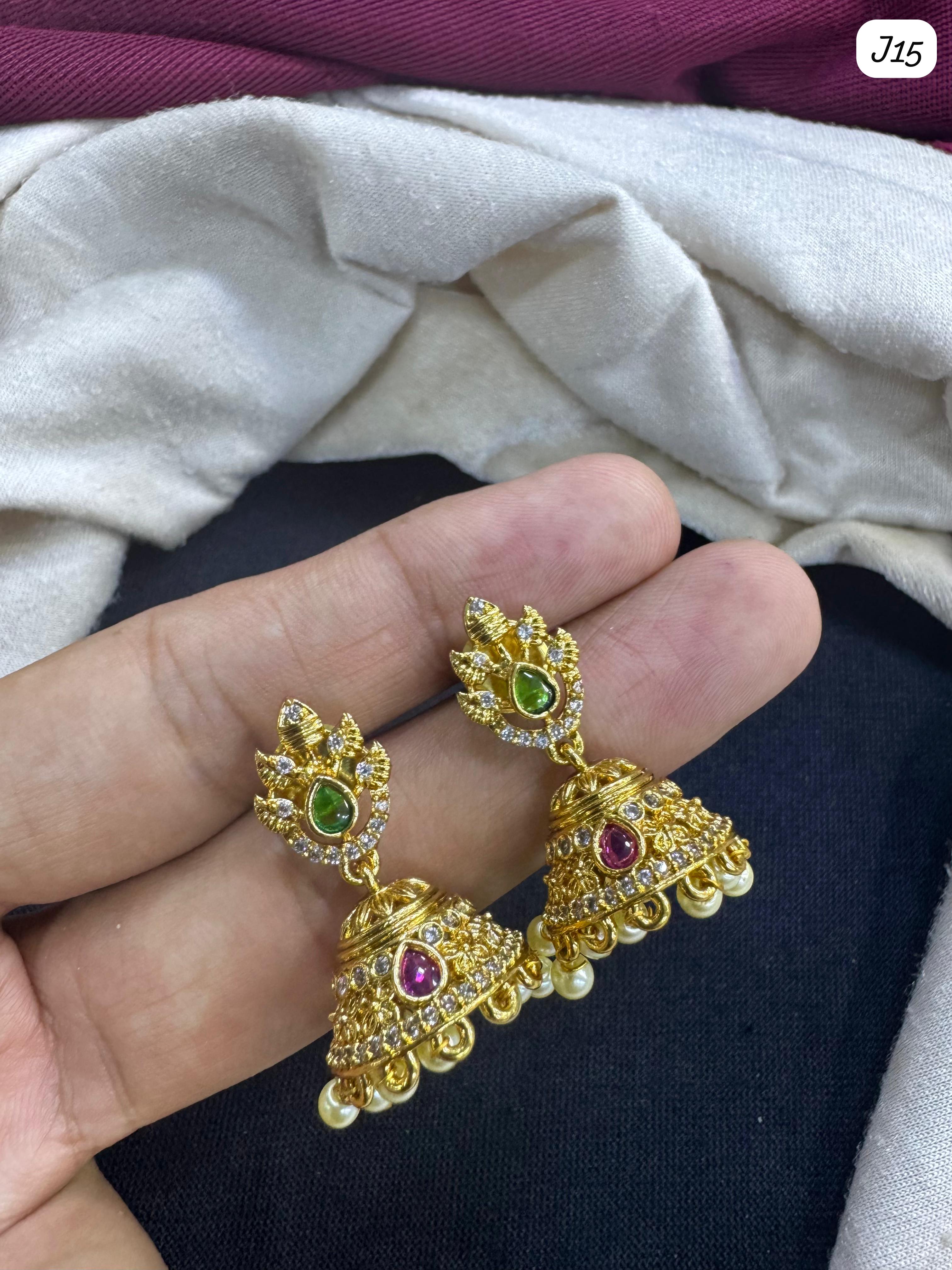 Elegant Gold Jhumka Earrings with Green and Pink AD Stones & Pearl Detailing